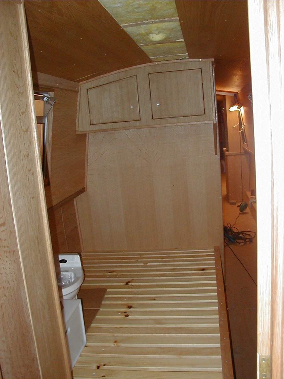 The bedroom starts to take shape. At last we can begin to imagine living onboard. We had Barry make 2 sets of drawers under the bed - one set in front of the other for extra storage. This space was created by having an elsan type toilet rather than the storage tank/pump out type.
