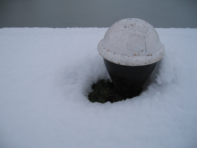 A bollard is almost covered in snow along the Buckby flight